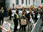 Protesters holding signs advocating housing as a human right during World Habitat Day
