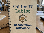 Spiral notebook with text Cahier 17 Labiso Capacitation Citoyenne and a gear-and-people logo