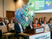 Man speaking at podium during Social Economy and Solidarity Congress with audience behind