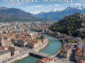 A city with red-roofed buildings and a river flowing through it, surrounded by green mountains and snow-capped peaks
